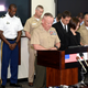 US military officials observe a moment of silence to mourn the death of a 20-year-old Japanese woman, during a news conference in at Camp Foster in Okinawa, Japan, May 28, 2016.